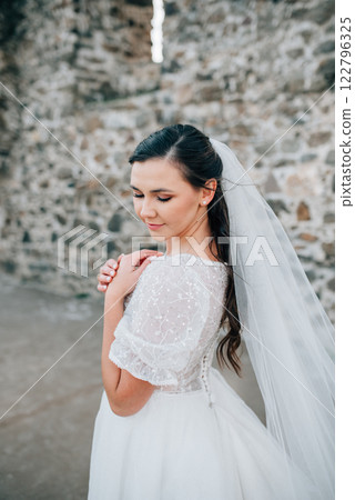 Stunning bride in a snow-white wedding dress with short sleeves. Stunning bride in a snow-white wedding dress with short sleeves. 122796325