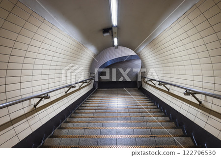 Underground Subway Tunnel Staircase with Symmetrical Architecture and Lighting Underground Subway Tunnel Staircase with Symmetrical Architecture and Lighting 122796530