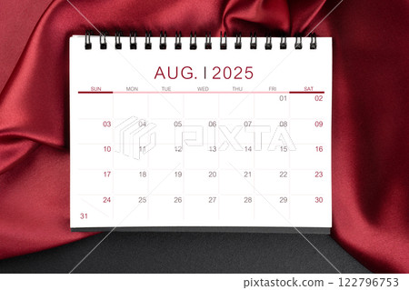 August 2025 Monthly desk calendar with red silk on black leather background. 122796753
