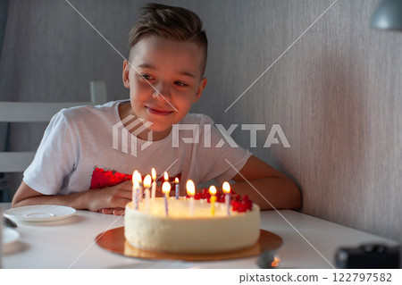 Happy Boy Celebrating Birthday with Cake 122797582