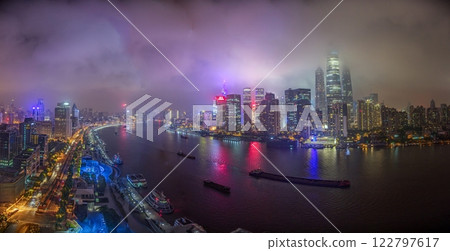 Night view of Shanghai skyline over Huangpu River with colorful reflections Night view of Shanghai skyline over Huangpu River with colorful reflections 122797617