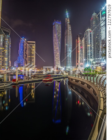 Panoramic night view of Dubai Marina skyline with waterfront reflections Panoramic night view of Dubai Marina skyline with waterfront reflections 122797619