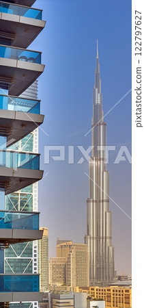 Burj Khalifa against a clear blue sky with modern architecture in the foreground 122797627