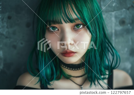 Young asian woman with striking green hair gazes intensely. Moody lighting enhances her enigmatic expression, set against dark, blurred background. Neural network AI generated 122797657
