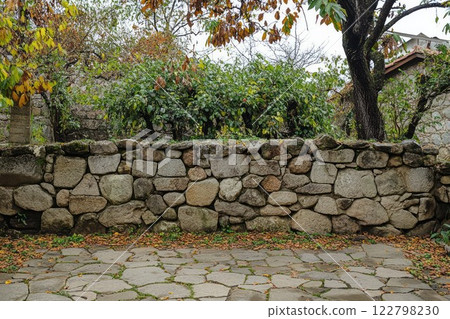 Stone pathway through lush forest on overcast day. Neural network AI generated 122798230