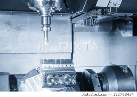 The 5-axis CNC milling machine cutting the automotive part in the light blue scene. The 5-axis CNC milling machine cutting the automotive part in the light blue scene. 122798434