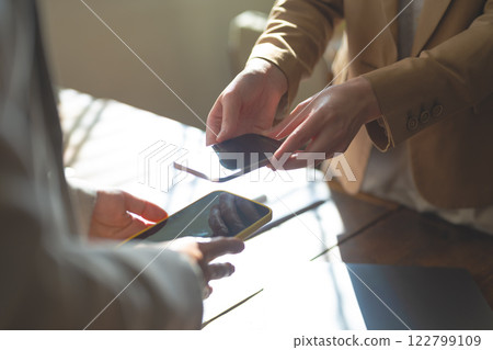 A scene where something is exchanged digitally 122799109