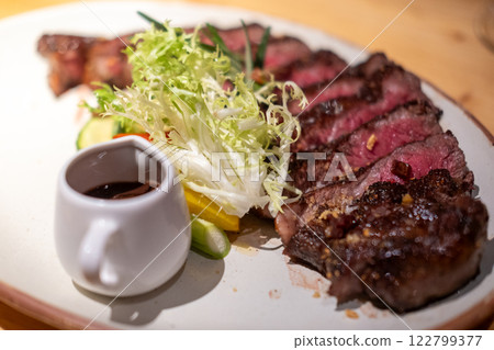 Medium rare wagyu meat served on plate with sauce and vegetable 122799377