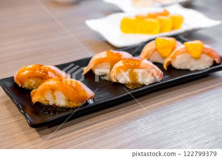 Set of Salmon aburi sushi with sauce on plate 122799379