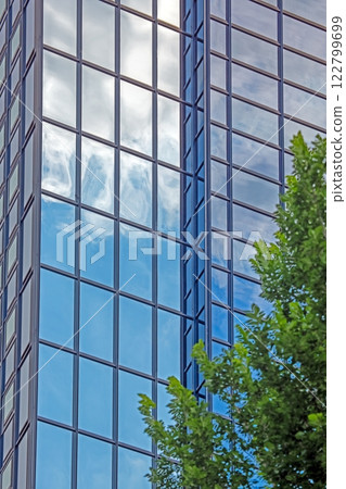 Close up of modern glass facade reflecting blue sky in Frankfurt Close up of modern glass facade reflecting blue sky in Frankfurt 122799699