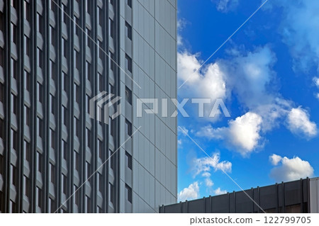 Close up of modern glass facade reflecting blue sky in Frankfurt Close up of modern glass facade reflecting blue sky in Frankfurt 122799705
