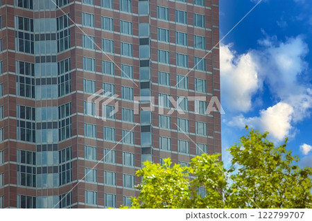 Close up of modern glass facade reflecting blue sky in Frankfurt 122799707