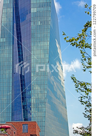 Close up of modern glass facade reflecting blue sky in Frankfurt 122799709