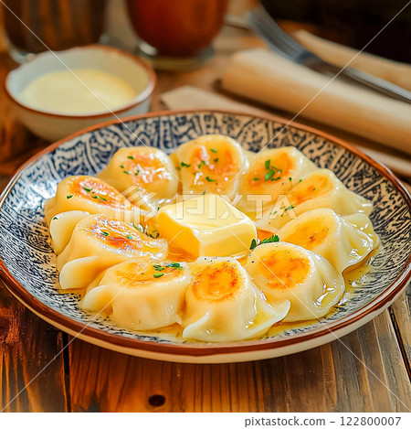 Steamed dumplings with butter served on a plate 122800007