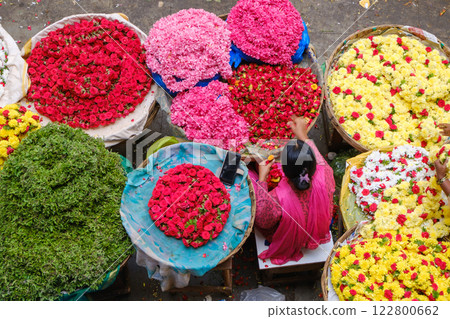 A merchant selling garlands at KR Market in Bengaluru, India A merchant selling garlands at KR Market in Bengaluru, India 122800662