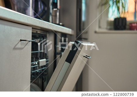 Open dishwasher in modern kitchen interior Open dishwasher in modern kitchen interior 122800739