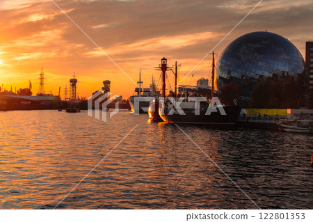 Pregolya River and ships in Kaliningrad at sunset. Russia Pregolya River and ships in Kaliningrad at sunset. Russia 122801353