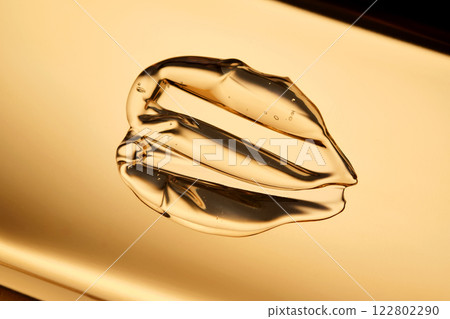 Tasty texture of cosmetic gel on a golden background. 122802290