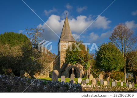 Burwash, East Sussex, UK: St Bartholomew's Church in Burwash with cemetery, trees and wall. 122802309