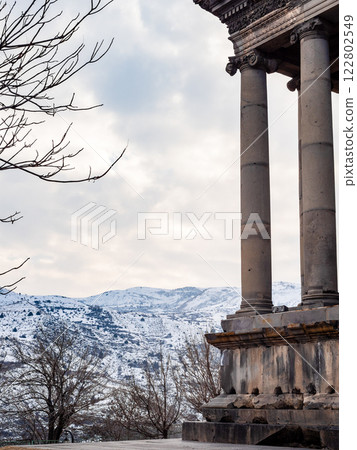 cloudy sky over mountains and Garni Temple columns 122802549