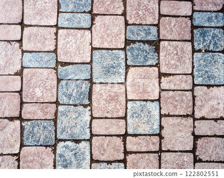 brown and gray stone tiles on path surface 122802551