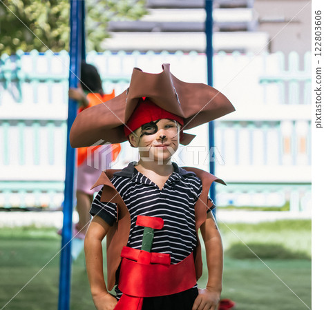 Boy Cat Pirate costume. Halloween party in kindergarten. Aqua makeup painted kids face. Bright festive 122803606