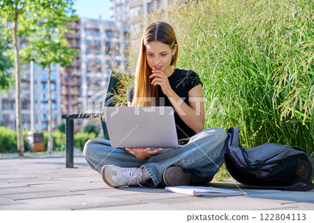 Young female college student using laptop computer outdoor 122804113