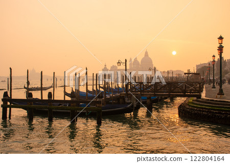 Enjoy the Serene Sunrise over the Beautiful Venetian Canals and Elegant Gondolas 122804164