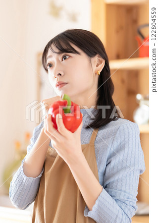 Woman thinking about menu in kitchen 122804559