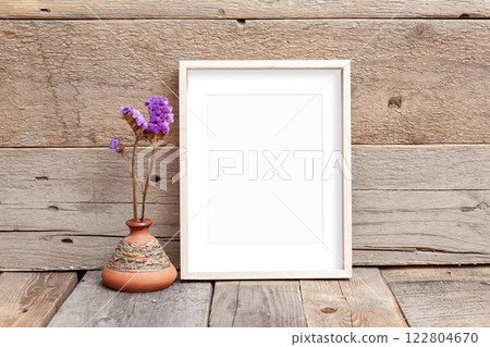 Wooden frame 8x10 on wooden background. Ideal for displaying your artwork. Wooden frame 8x10 on wooden background. Ideal for displaying your artwork. 122804670