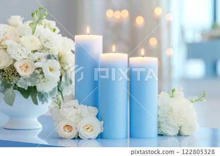 Cobalt blue candles and floral arrangements create a stunning centerpiece for a wedding event 122805328
