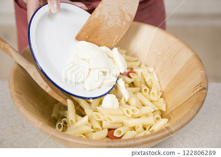 Adding Mozzarella to Pasta, Food Photography, Close View Background Adding Mozzarella to Pasta, Food Photography, Close View Background 122806289
