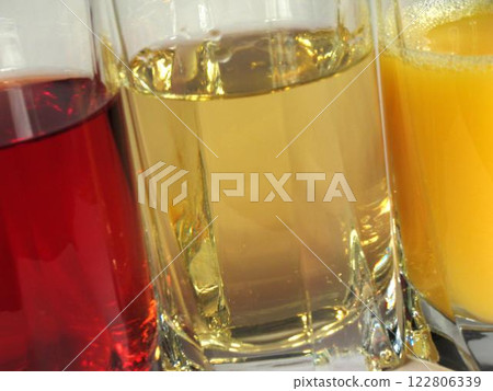 Apple, orange and grape juice in transparent glasses 122806339