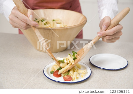 Person Serving Pasta Background 122806351