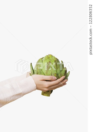 Person Holding a Globe Artichoke, Close View Background, Food Photography 122806352