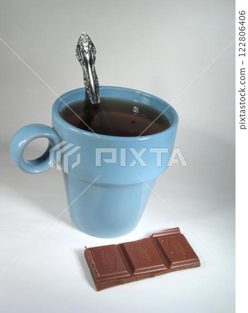 Cup of coffee with a chocolate bar, dessert over white background 122806406