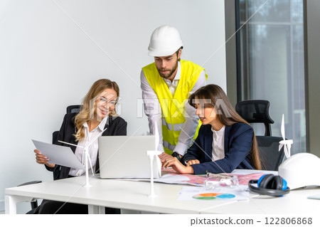 Group of people working in the office on a new green energy project Group of people working in the office on a new green energy project 122806868