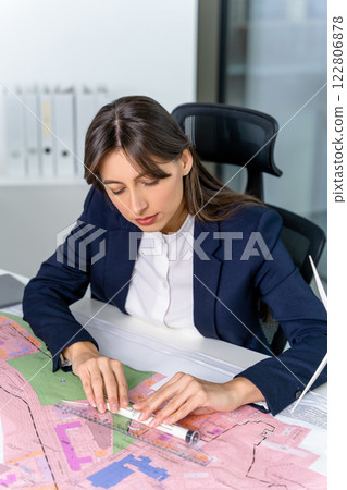 Female engineer working in the office on a new project Female engineer working in the office on a new project 122806878