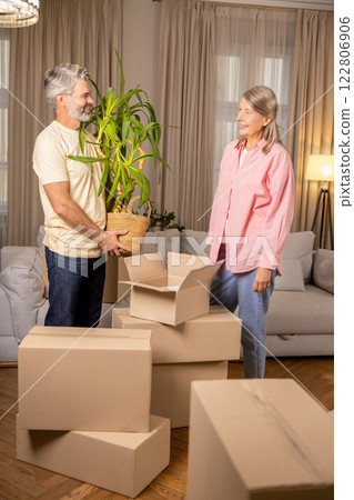 Senior family unpacking stuff in living room of their new apartment Senior family unpacking stuff in living room of their new apartment 122806906