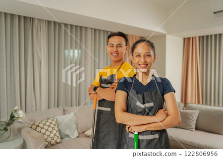 Cheerful Professionals Wearing Aprons Posing Together in a Modern Living Room 122806956
