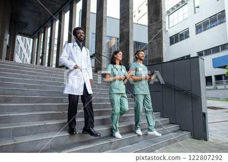 Doctors colleagues on the steps going from the rehabilitation center Doctors colleagues on the steps going from the rehabilitation center 122807292