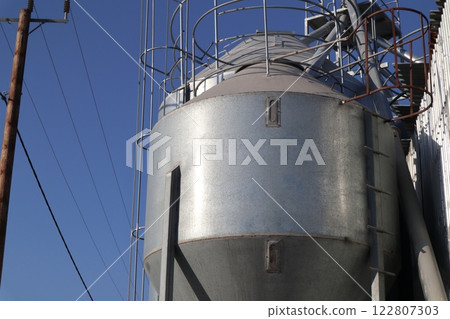 Farm animal feed storage, feed dispenser, farm equipment. Livestock farm. Farm animal feed storage, feed dispenser, farm equipment. Livestock farm. 122807303
