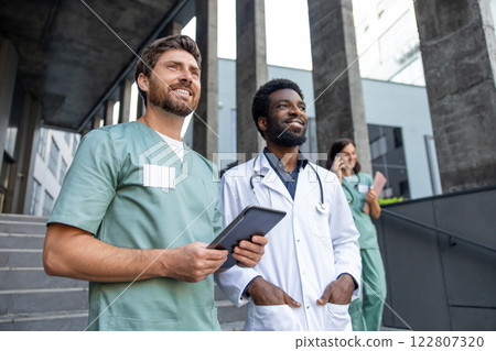Two male doctors on the clinic stairs looking confident and determined 122807320