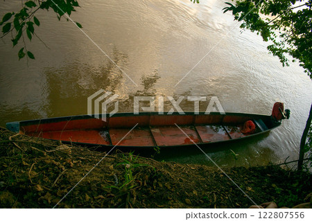 Canoe Moored on a Riverbank Canoe Moored on a Riverbank 122807556