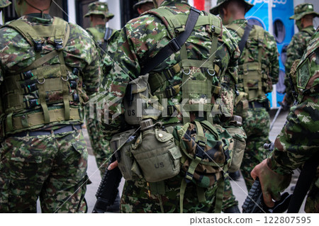 Colombian army patrolling the streets, military forces on urban patrol in Colombia, soldiers securing the streets in Colombia, army troops conducting street patrol, Colombian military presence in Colombian army patrolling the streets, military forces on urban patrol in Colombia, soldiers securing the streets in Colombia, army troops conducting street patrol, Colombian military presence in 122807595