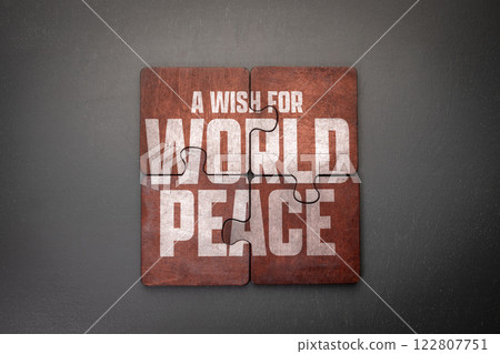 A Wish for World Peace. Wooden puzzle pieces with text on a dark office table 122807751