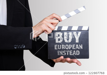 BUY EUROPEAN INSTEAD concept. Businessman showing movie clapper BUY EUROPEAN INSTEAD concept. Businessman showing movie clapper 122807768
