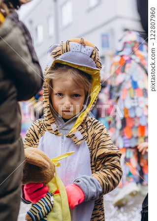 5-year-old girl in a tiger costume at a carnival in Germany, full of joy and excitement. 122807960