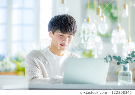 A man looking at a personal computer 122808345