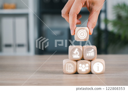 Wooden blocks with business icons representing market research, strategy, and analysis for planning and growth. Wooden blocks with business icons representing market research, strategy, and analysis for planning and growth. 122808353